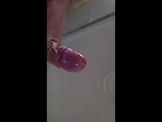 Pulsating cock glistens under running water