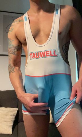 Smooth jock in wrestling singlet jerks off and cums