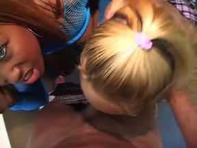 Black beauty and blonde babe take turns sucking stud's tool on the floor