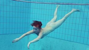 Busty redhead European college girl in the pool naked