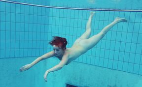 Busty redhead European college girl in the pool naked