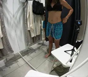 Girl undresses and touches herself in public in the dressing room of a clothing store.