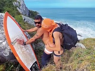A cheeky surfer getting a dick and piss from a tourist.
