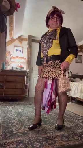 dressed in a small leopard skirt and a yellow blouse for an evening out
