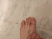 Boy showers in speedo swimsuit and soaps his feet