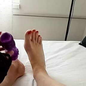 Milf tranny simulates a Footjob with a vibrator between her red painted toes