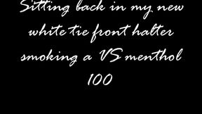 Sitting in a white halter smoking a VS 100