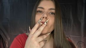 Latina smokes and holds the smoke in before exhaling