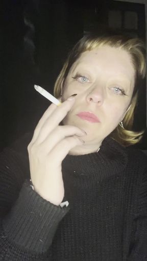 Seductive vixen smokes and applies lipstick