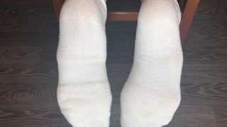 STUDENT GIRL SHOWS WHITE SOCKS AND FEET AFTER STUDYING.