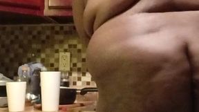 Exposed woman cleaning kitchen