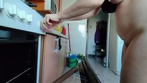 Sexy wife having fun in the kitchen with roses.