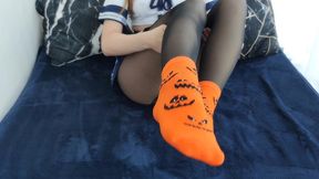 sockjob in orange halloween socks
