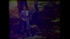 Marine Corps aviation cadet shakes hot white coconuts from the veiny love tree outdoors