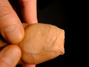 Very Close up on the tip of his uncut penis as he plays with his foreskin and show bell-end