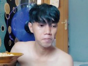 Handsome young man is eating noodles without using t shirt