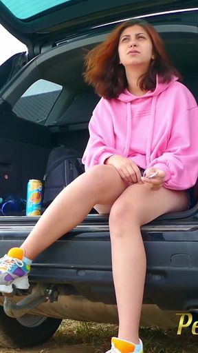 Wetting Her Jeans Outdoor - Desperate Hipster Girl Trying Hard to Pee - Pee Next to the Wheel of the Car