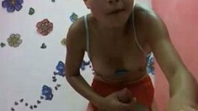 Petite Asian tranny jerks her big cock off in front of a webcam