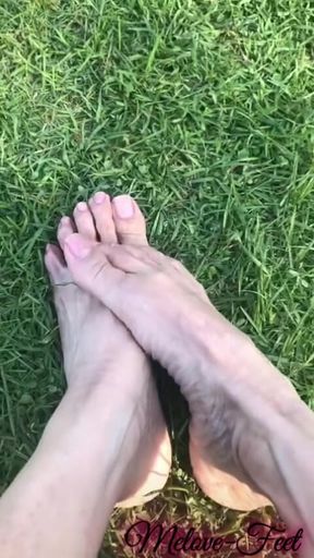 Melove Showing Her Sexy Small Feet on Green Grass