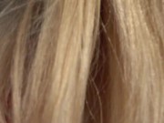 PUBLIC ON A BENCH. A SUNNY DAY A CUTE PUSSY