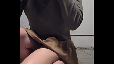 Shemale Ting Xuan masturbates outdoors in a miniskirt and high heels.