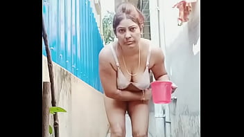 Desi aunty bathing outside