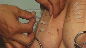Mature Redhead MILF Endures Needles and Heavy Weights