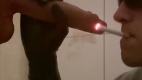 Smoking a cigarette and giving head to a big dick