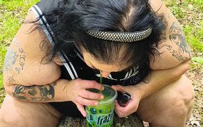 Sucking on a Straw in the Woods Squirting on Tree on Her Knees