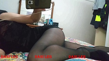 Dani Leg on bed in black pantyhose showing off curvy legs and round ass