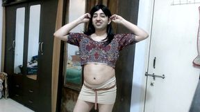 Sexy sissy crossdresser femboy Sweet Lollipop in a printed blouse and nude skirt.