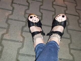 a crossdresser with astonishing feet walks on the street in high heel wedges and taut jeans and tempts boys