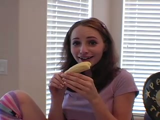 She eats banana and teases camera with gentle bites and licking