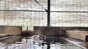 Japanese girl bathing in a mixed outdoor bath at a hot spring inn