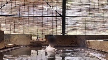 Japanese girl bathing in a mixed outdoor bath at a hot spring inn