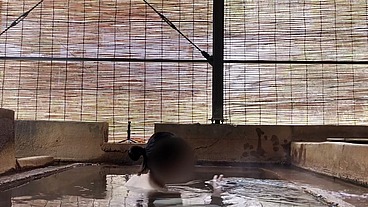 Japanese girl bathing in a mixed outdoor bath at a hot spring inn