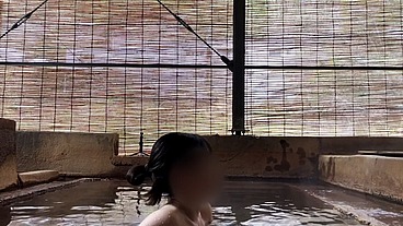 Japanese girl bathing in a mixed outdoor bath at a hot spring inn