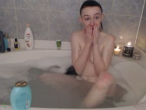 Naturally stuck amateur teen flashes her small tits in the bath tub