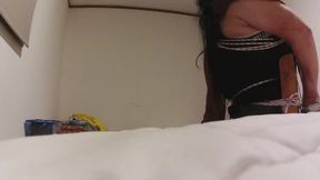 Crossdresser tied in chair in denin shorts