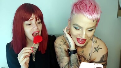 Tattooed Serbian redhead and pink-haired girl flirt on webcam from their living room