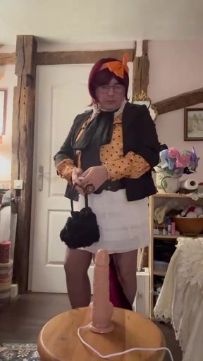 In an outfit with a little white skirt to suck a dildo