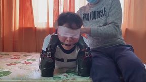 wn8-Put a gag in the woman's mouth, tape her limbs together, and then make her drool.