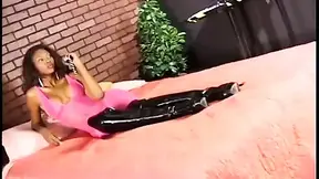 Seductive ebony dominatrix takes control of her male slave, whipping him into