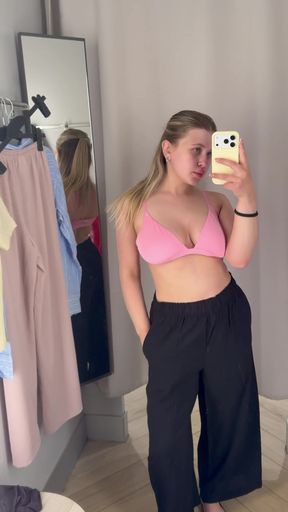 Slim blonde young adult poses in a cute dressing or fitting room