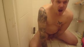 Man jerks off in the shower while riding a thick dildo.