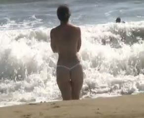 My sexy topless GF allows me to film her on a beach