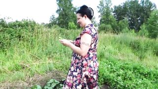 Big Boobed MILF masturbates with cucumber and strawberries outdoor into a outside place