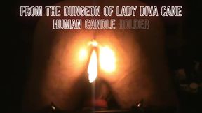 Human Candle Holder.  Hot wax dripping on the balls of a slave holding a lit candle in his ass for Lady Diva Cane.