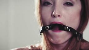 ”Nipple clamps & ball gag make a horny redhead cum hard”