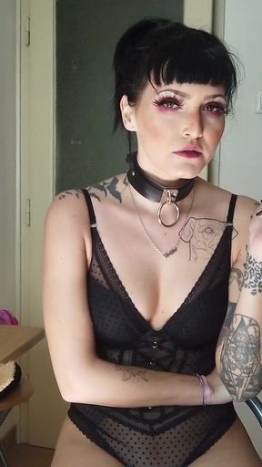Tattooed gothic lady smoking in the kitchen